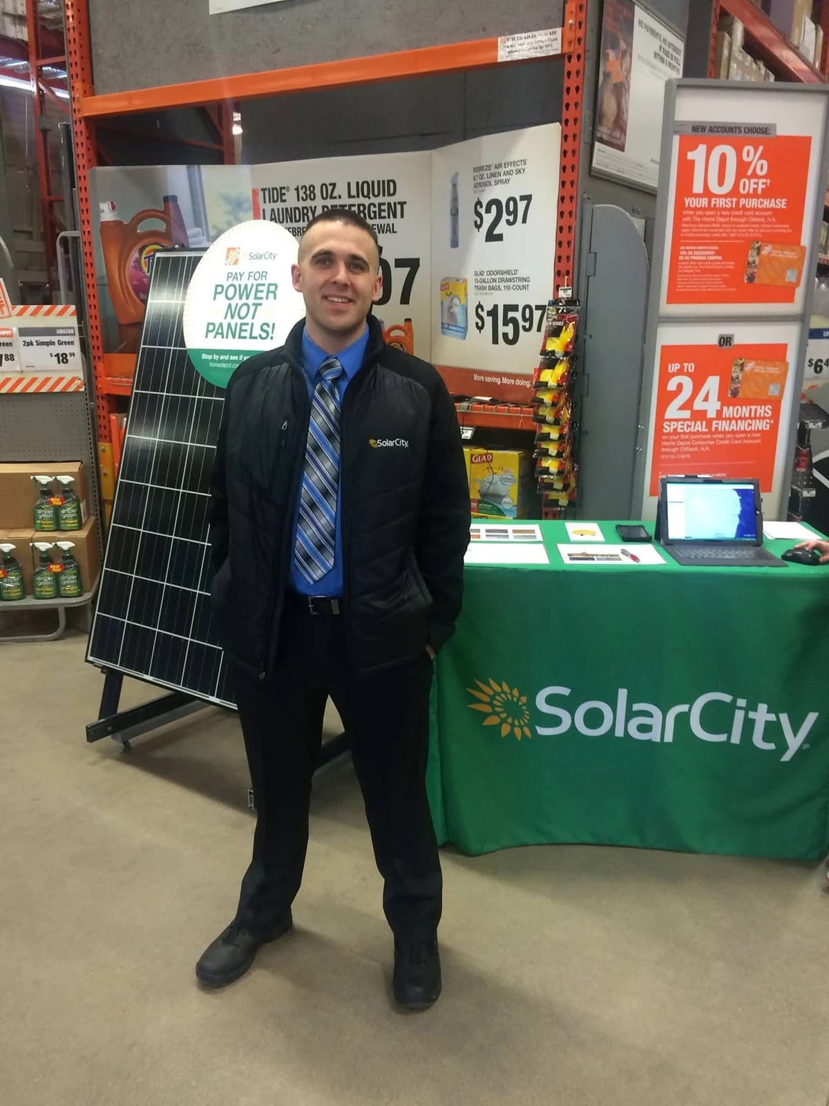 Jim Peterson beside an in-store solar display, around 2016.